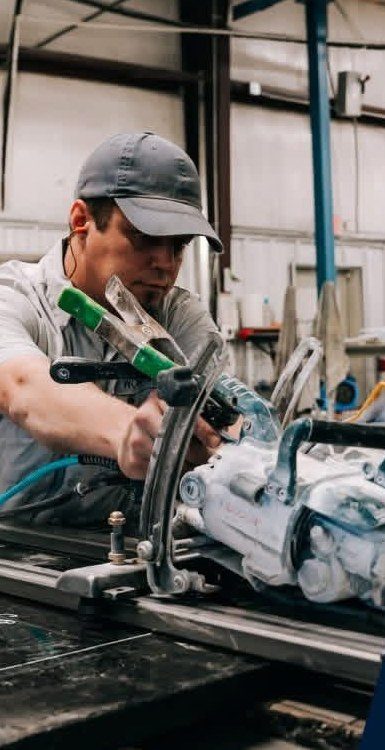 A fabricator cutting a stone slab in the shop